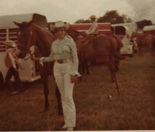 PHOTO OF MARSHA STANDING  BESIDE HORSE, DRESSED IN WHITE